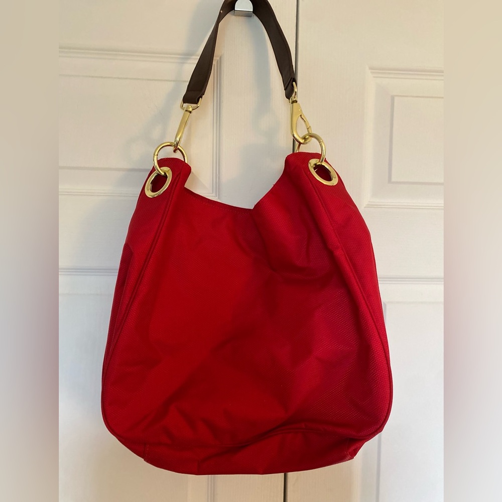 Red handbag. Gold accents brown handle